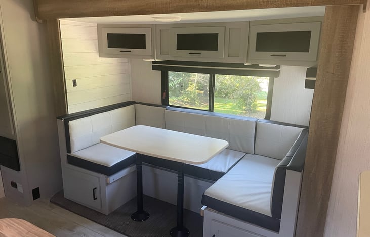 U-Shaped dinette table that converts to a twin size bed comfortable for one adult or two children. Storage above and below the table.