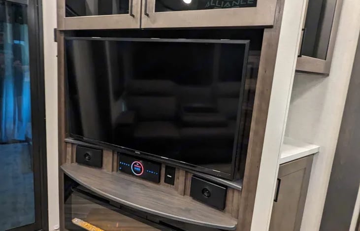 Living/kitchen area TV with a fireplace below.  Roku included.