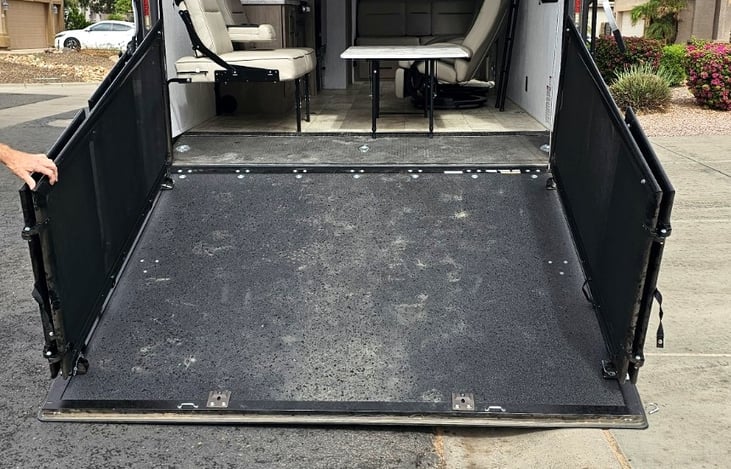 Versatile rear ramp with patio conversion to load toys.