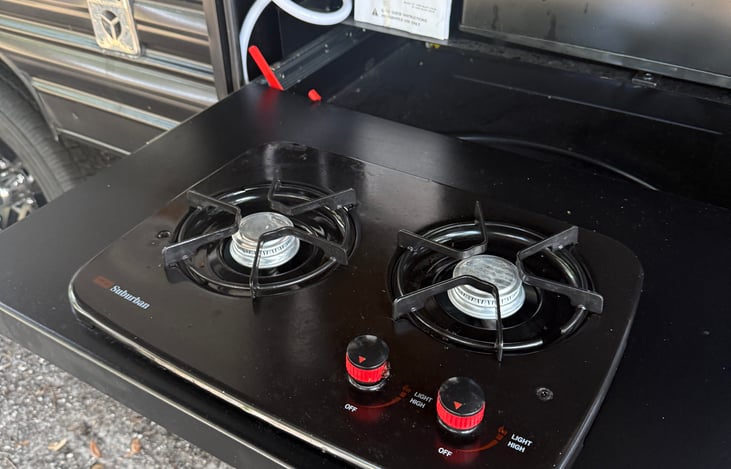 Outdoor cooking station features twin propane cooking surfaces, a mini refrigerator, and ice maker! Perfect for your outdoor cooking experiences and entertaining friends and family!