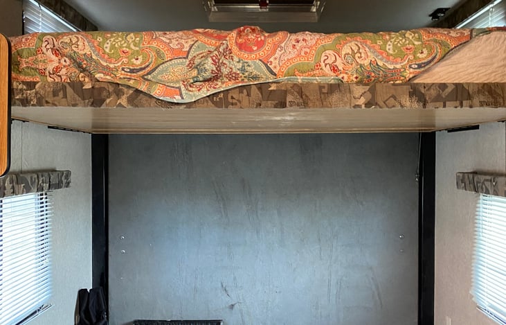 loft bed comes down from ceiling, access by ladder