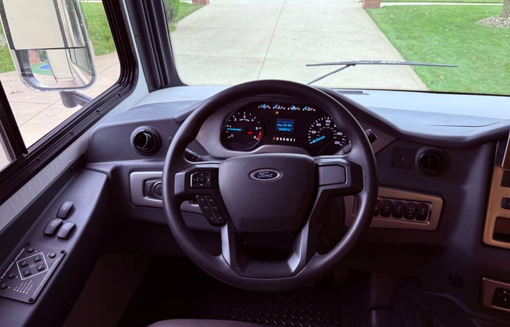 Driver’s captain chair, power leveling system controls, big screen sound system equipped with rear backing and side cameras.  Cruise control and AC.