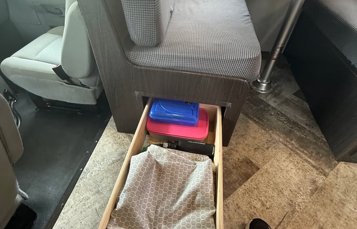 We provide a privacy curtain for the night time, bear spray, first aid kit in this drawer. This is located in the kitchen / game table bench seat on the left.