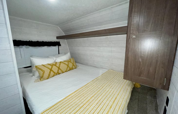 Full sized queen bed with additional storage and fresh linens