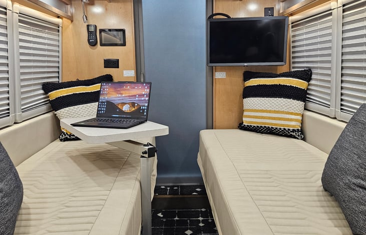 Sitting  / Sleeping area, with table and lighting.