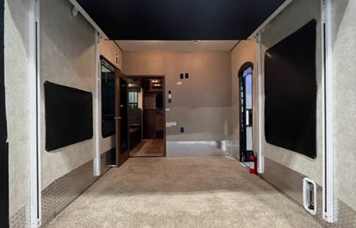 Anther photo of the rear bedroom and garage area. The black at the top is the upper bunk that lowers!