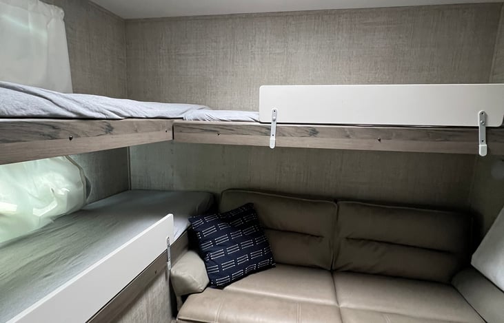 bunkroom with couch up and bedrails on