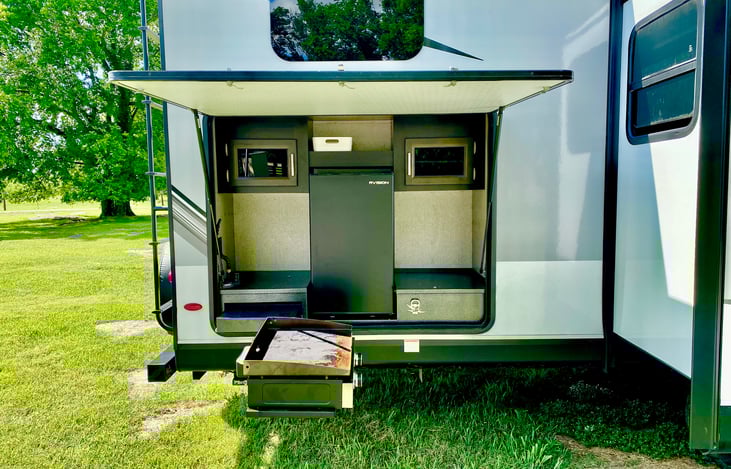 outdoor kitchen with refrigerator, workspace, and rent-able blackstone cooktop