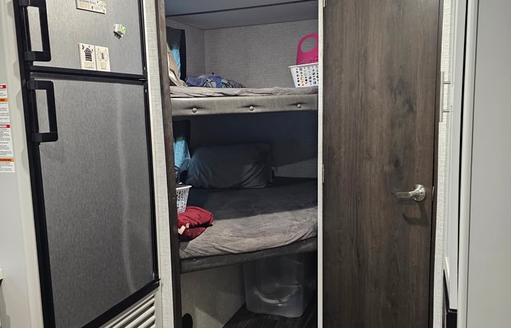 Two bunk beds with storage underneath.