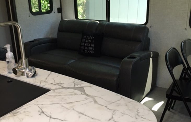 A large kitchen island that slides out with a huge basin sink. The extra large living room slide makes extra floor space for everyone.