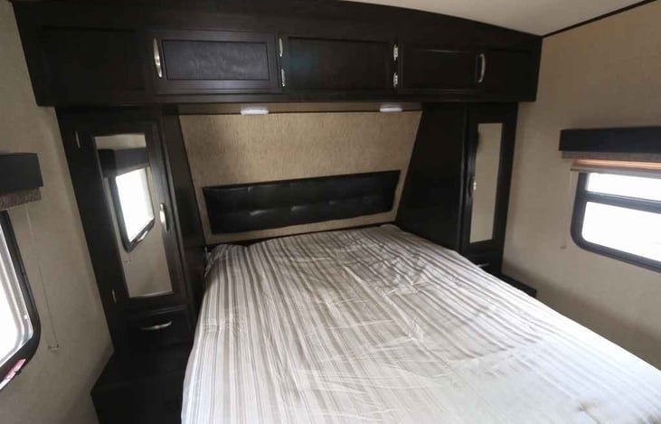 Queen Size Bed.  Linens will be provided.  On each side of the bed and above the bed are storage cabinets.  Also you can pickup the foot of the bed.  Under the bed is storage with chairs and games.