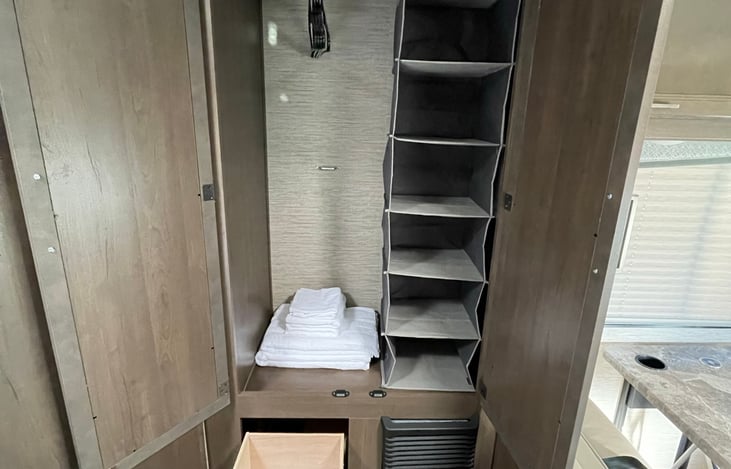 Mirrored closet with added closet organizer, hangers and set of towels included.