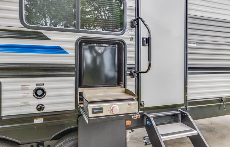 Outdoor fridge and flat grill area. Enjoy cookouts with friends.