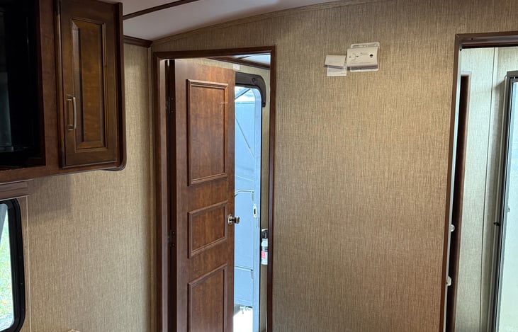 Large bedroom with a tv, private ac unit and LOTS of storage!