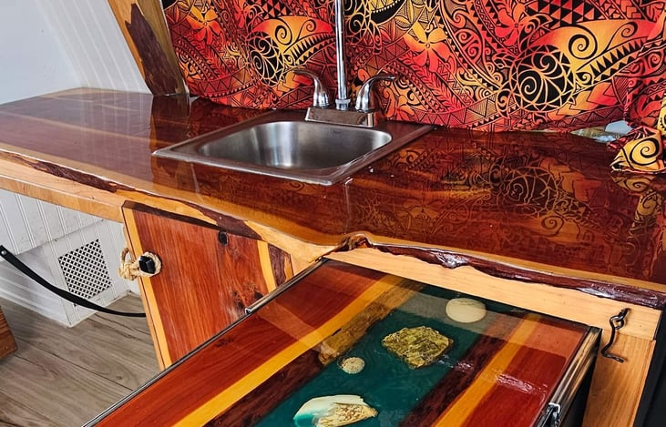 Pull out river pour table for a little side table. Readily accessible from the passenger seat that swivels around to face the rear
