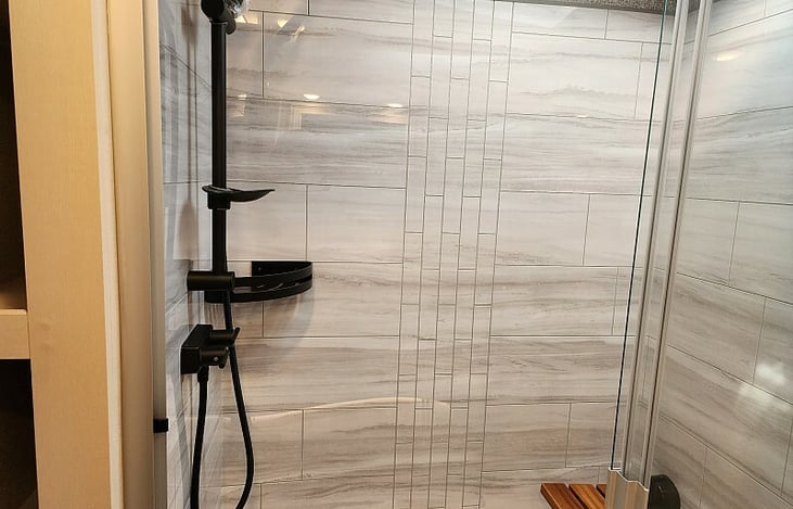 Large roomy shower with a fold down seat.