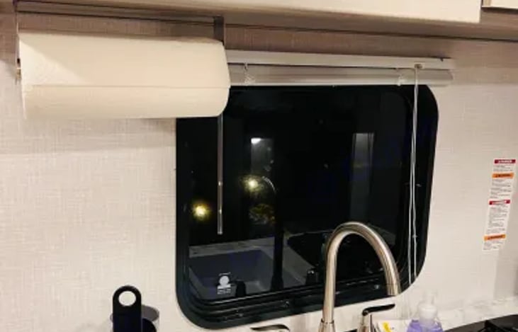 Kitchen with 2 burner stovetop, microwave and coffee maker.