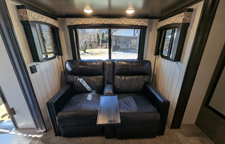 Very spacious living area offers a cozy retreat with theater-style recliners, a premium entertainment system, fireplace, TV, dinette and well-equipped kitchen.