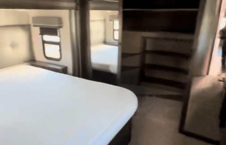 Master bedroom with queen sized bed. Inside the closet is a washer/dryer.