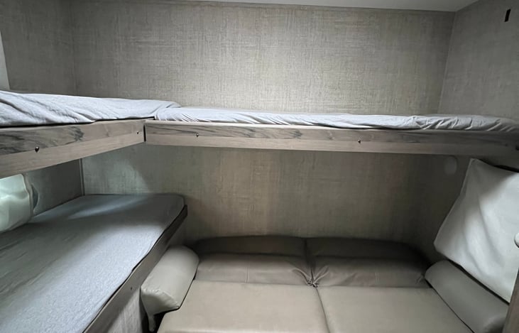 bunkroom with couch folded out and bedrails off