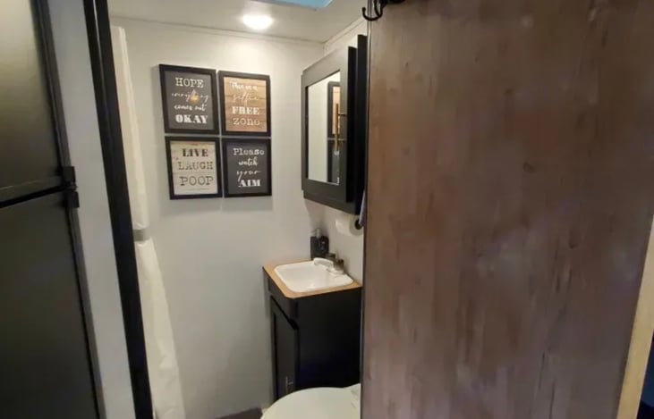 Bathroom with vanity, toilet and shower.