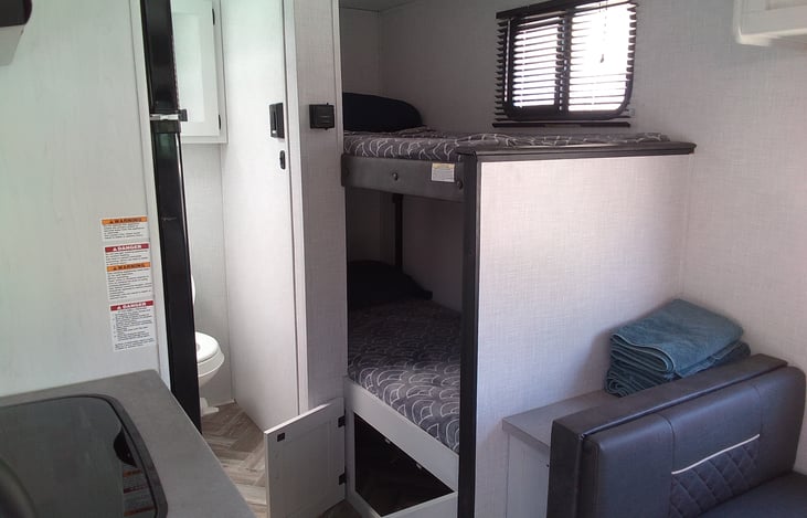 Two twins in the bunkhouse, with plenty of under bunk storage and bonus pass through 😀