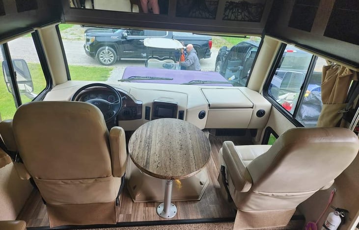 Passenger "Home Office" area with flip over desk and charging station with 2 outlets.  Plenty of leg room and a window for your fur-baby to watch the world pass by.