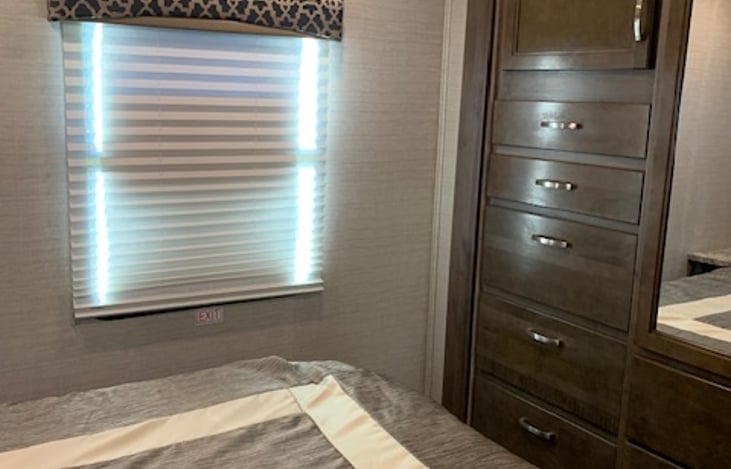 queen bedroom with shade option