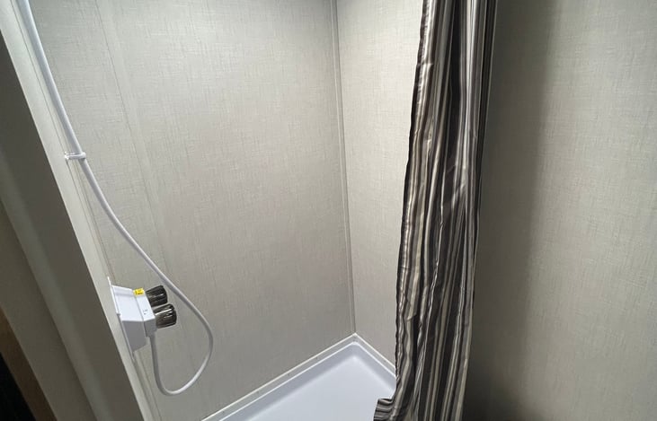 Bathroom comes with standing shower and tiolet