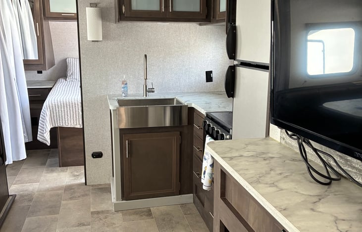 This TV is rotatable and can be directed towards the living room, kitchen, or the master bedroom.