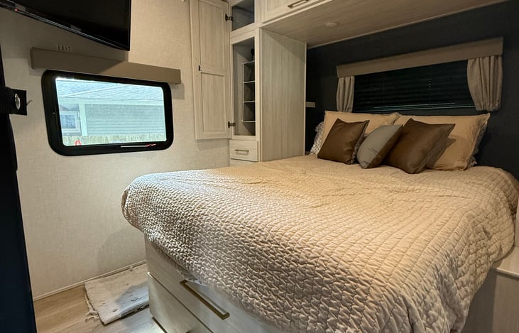 Queen size bed with storage on either side of the bed.