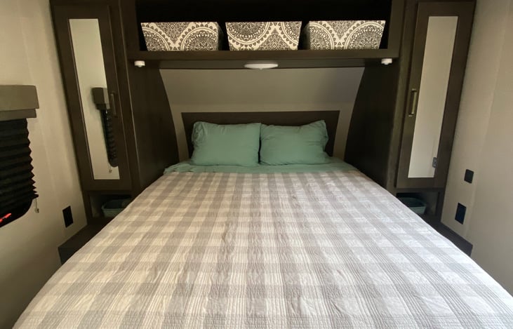 Queen bed with foam mattress topper in private master bedroom. Lots of closet space on each side of the bed, plus storage above. USB port on right side and power outlets on both sides. 32' TV.