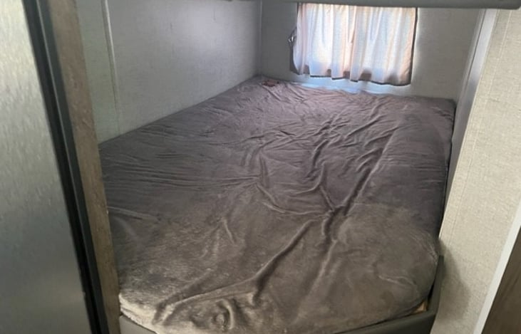 Extra large bunk beds with plush padding. Lower bunk has separate window and ceiling light fixture.