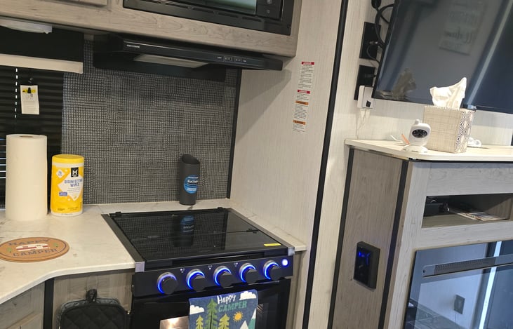 Why, yes our oven has cool blue lights and an over heard microwave but I suggest letting the husband use the outside kitchen to cook while you relax