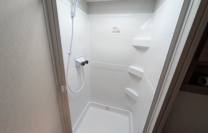 Spacious bathroom with large shower.