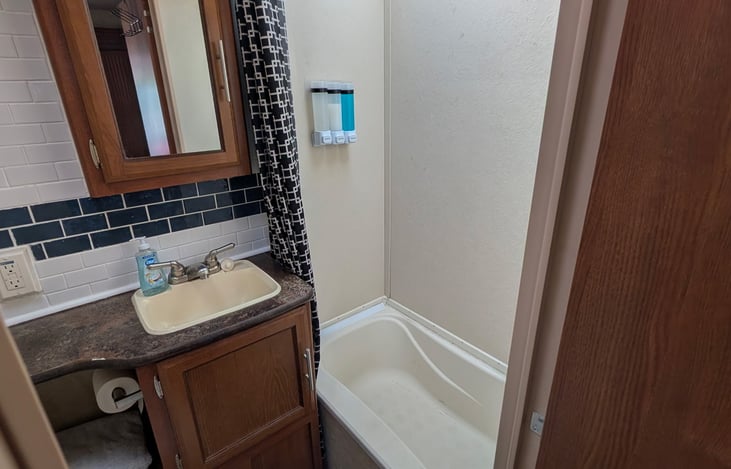 Full bathroom with tub and shower.