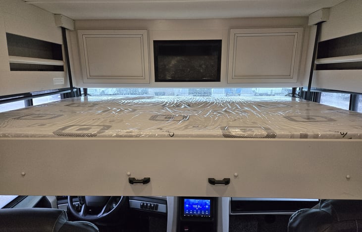 View of forward overhead drop down bed with LED TV.