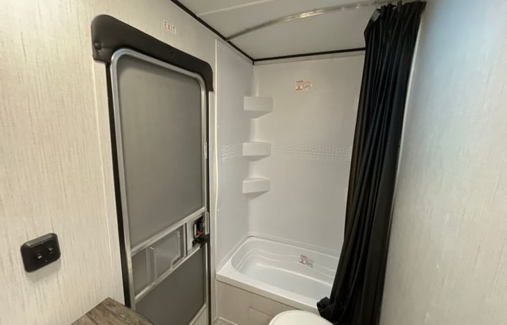 Full height shower with tub, toilet, and vanity