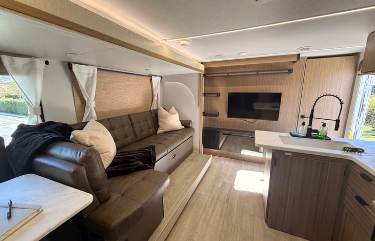 “Spacious living area with seating & TV”