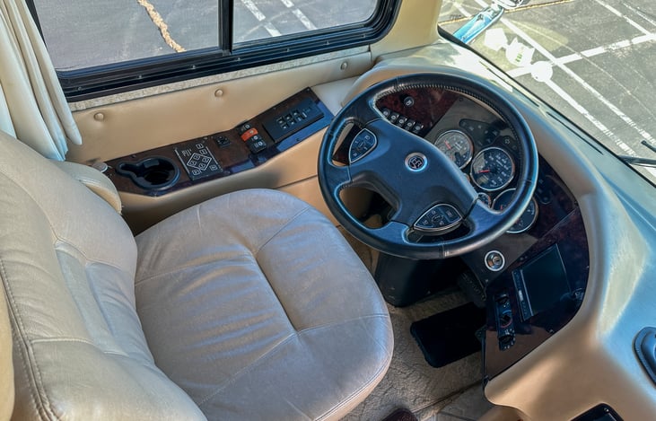 Driver seat with tilting and telescoping wheel.