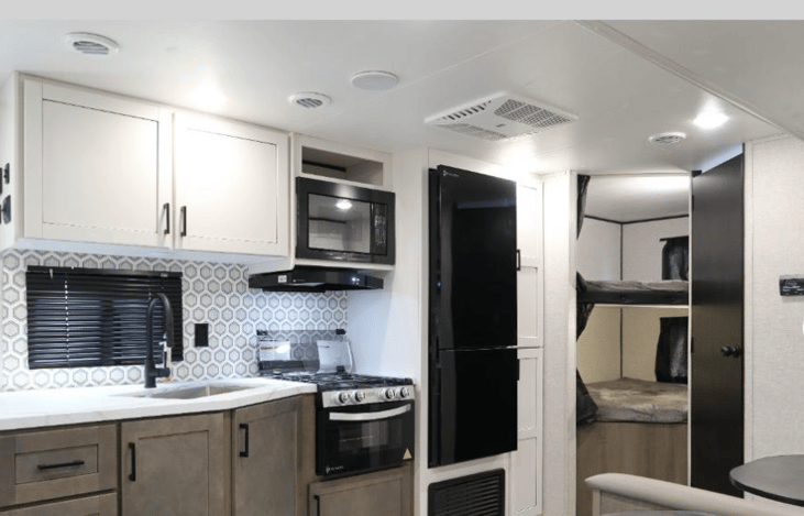 Facing kitchen area and double bunk beds~