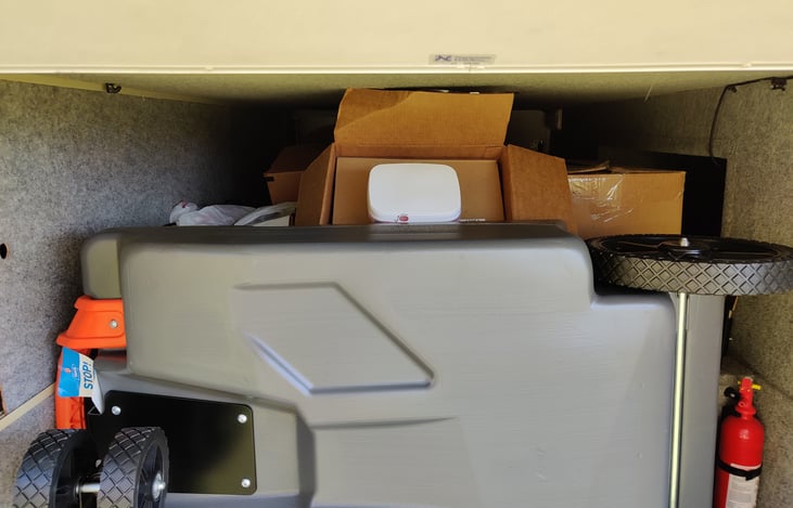 massive storage with slide out tray. Comes with portable dump tank, all hookups, hoses, whips, etc.