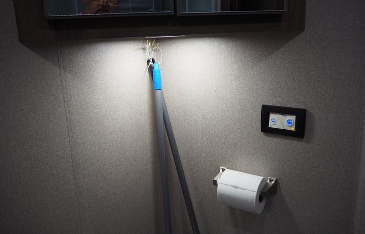 Bathroom with electronic toilet controls