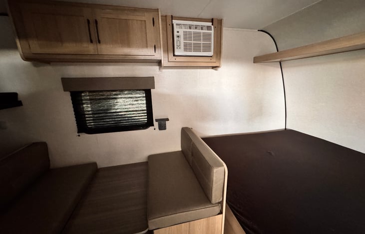 2025 Coleman 17B - Dinette and Queen Bed, added a topper and zipper sealed mattress cover.