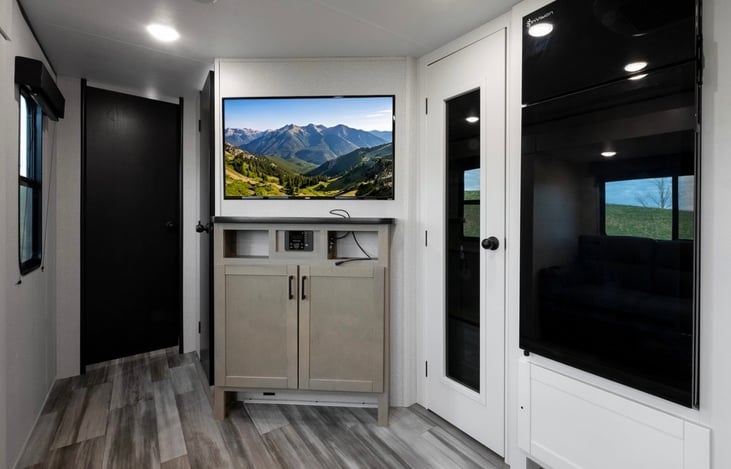 JayBird, Fridge, Pantry, TV/entertainment area and doors to private bath and private bedroom.