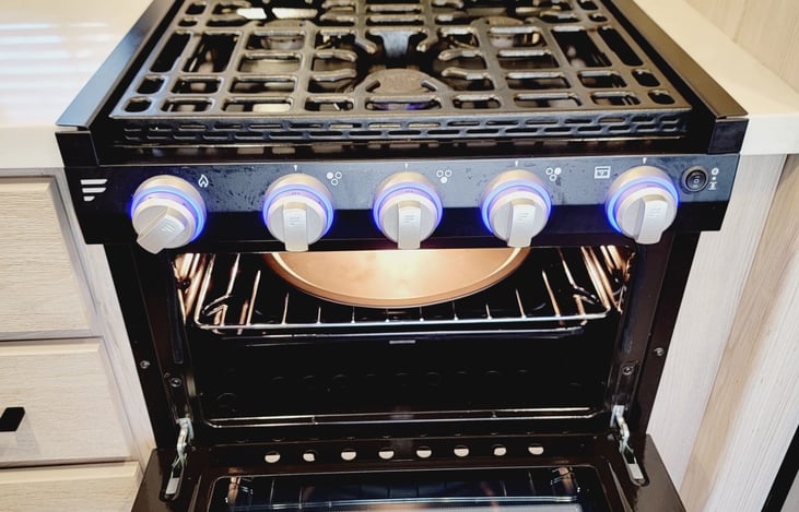 3 burner stove with glass cover and oven.