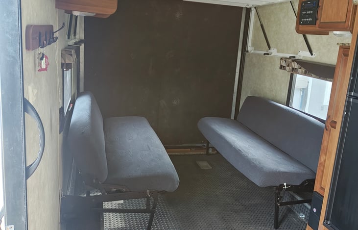 These two sofas either fold out to make one big bed or fold up against the wall to make extra room for hauling toys or setting up the dining table.