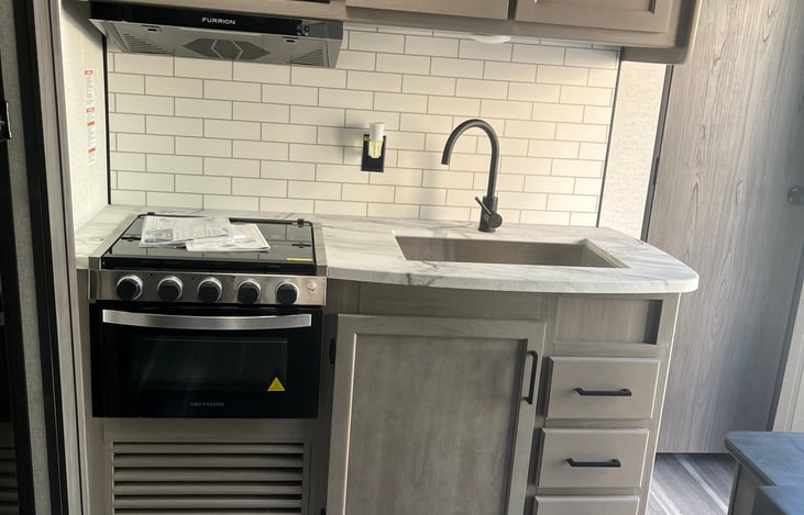 Kitchen with 3 burner gas stove and oven