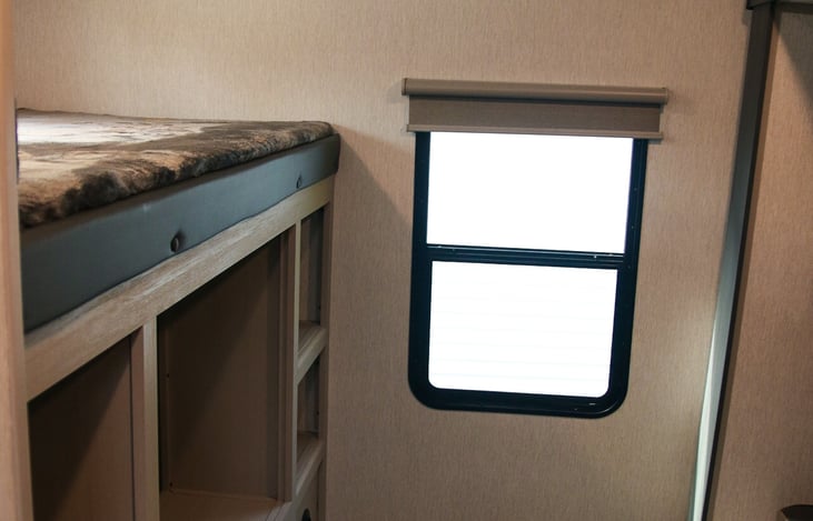 Top bunk with plenty of storage below.