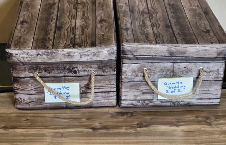 Under dinette storage showing bins for dinette bedding.